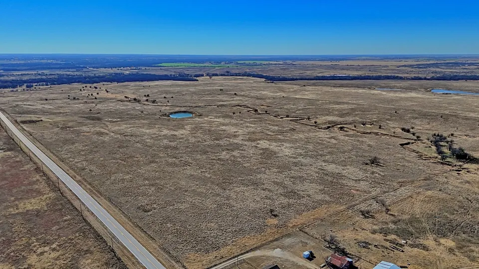 Expansive Clay County ranch land with stock ponds, creek, and distant tree line