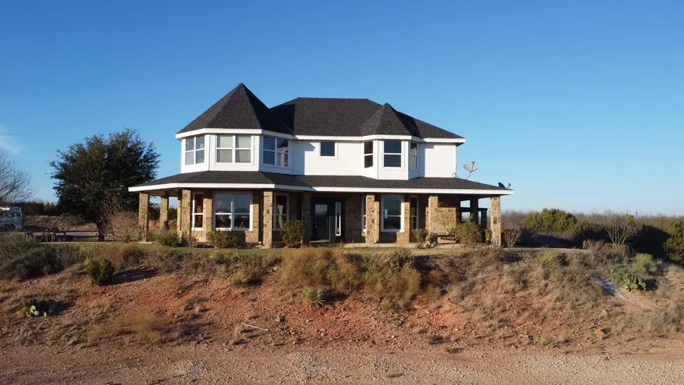 Two-story home with stone-columned porch sits atop a red-dirt hi, 80 acres in Taylor County, 80.97 acres in Taylor County, TX