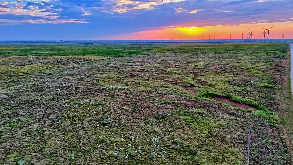 Expansive Texas ranch land at sunset, with distant wind turbin, 928 acres in Archer County, 928.00 acres in Archer County, TX