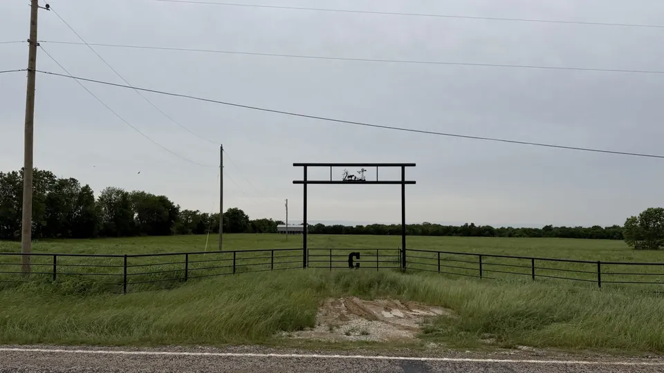 Ranch entrance with metal gate and decorative windmill and deer silhouette overlooking, Untitled Draft, acres in County, TX
