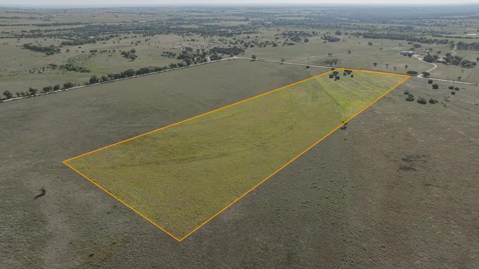 Pastureland in Texas ranch property outlined in orange, with scattered trees and native grasses, Texas ranch, Texas